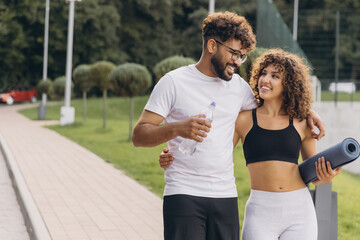 Happy arab couple walking together after outdoor training