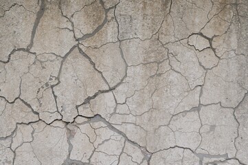 Fototapeta premium Detailed close-up of weathered concrete surfaces showing cracks and intricate textures