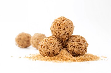 Dried Shikakai Pods and Acacia Concinna Soap Bobs on a White Backdrop
