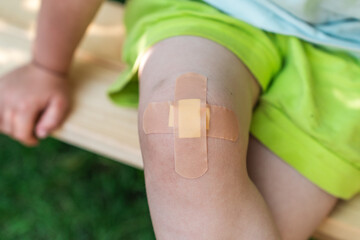Little child with Band-Aid on her knee