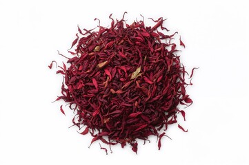 Naklejka premium Dried red Hibiscus tea leaves arranged in a heap, top-down view on a white surface.