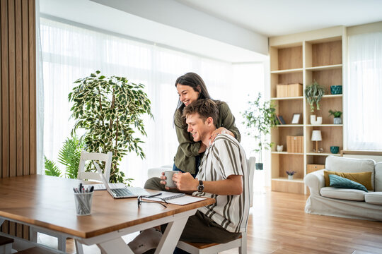 Happy couple remote working together from home