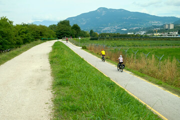 Obraz premium Bikers travels along a country road in Trentino, Northern Italy, during a sunny day