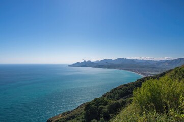 Fototapeta premium Ocean vista from the mountain peak in a coastal region