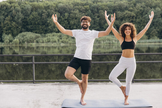 Happy arab couple practicing yoga together outdoors
