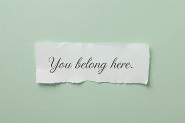 You Are Welcome Here Message on Torn Paper Against Green Backdrop. Symbolic Representation of Belonging. Space for Text.