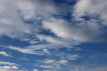 Blue sky with fluffy white clouds
Bright blue sky with soft white clouds, natural background for design and illustration.