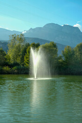 Fototapeta premium Pond with fountain in Gardolo, Trento, in Northern Italy
