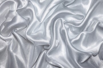 Obraz premium Gleaming silver satin displaying creases, ripples, reflections, and surface details