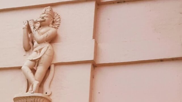 Krishna sculpture at Shri Ram Mandir, Chaphal, Satara, symbolizes divine love, spiritual awakening. This depiction, with Krishna playing bansuri, aligns with ISKCON aesthetics on devotional imagery.