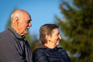 Fototapeta premium Side Profile of a Happy Elderly Couple at Sunset