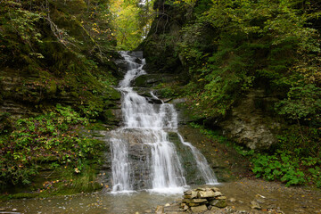 Waterfall Seredniy Huk, Bukovynski cascades in Velykyi Roztoky in the autumn forest. Carpathian Mountains, Chernivtsi oblast, Ukraine.