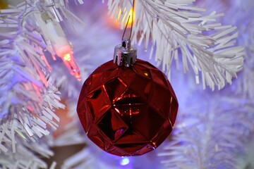 Red Textured Ornament Hanging on White Christmas Tree