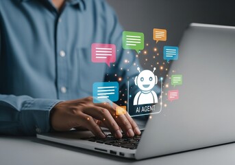 Fototapeta premium Person typing on silver laptop with glowing AI Agent chatbot icon and colorful speech bubble overlays for communication