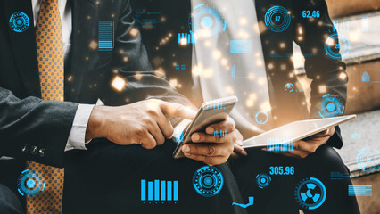 Two business professionals engage with a smartphone and tablet, featuring a digital overlay of analytics, demonstrating modern communication and technology in the workplace. Xenic