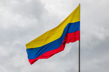 View of the colombian flag with a cloudy background.