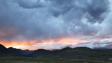 Beautiful drone sunset view over storm clouds mountain landscape