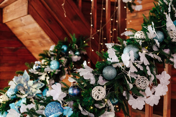 Beautifully decorated staircase with festive garland and ornaments in cozy cabin setting