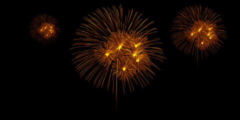 Fototapeta premium Golden fireworks explode in the dark night sky celebrating joy and freedom with radiant displays of light against a