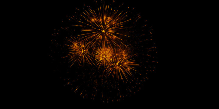 Golden fireworks light up the night sky in a dazzling display of celebration filling the darkness with hope against a
