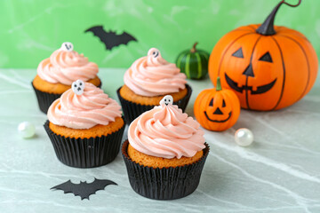 Spooky Halloween Cupcakes with Ghost Toppers and Pumpkin Decor