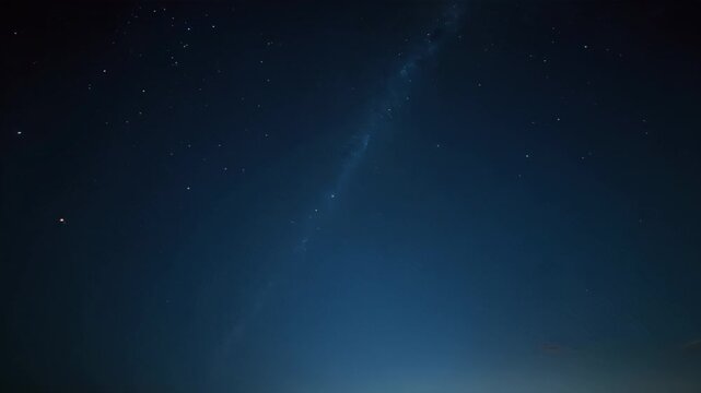 Long line of stars in the sky above a beach