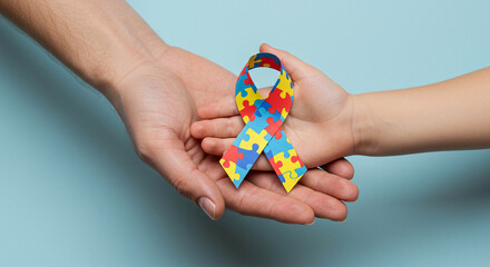 hands holding puzzle ribbon symbolizing autism awareness. AI-generated image