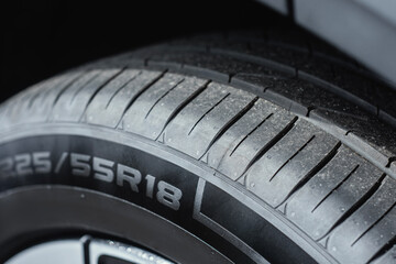 Car tire showing clean rubber surface and detailed tread pattern. Concept of automobile safety, vehicle maintenance and car service.