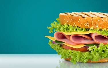Fototapeta na wymiar Tasty fresh big sandwich with ham, and vegetables