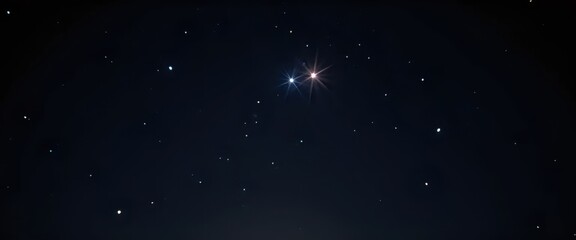Fototapeta premium A bright star shines brightly in the dark night sky.