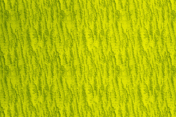 Vibrant lime green textured fabric close up abstract background