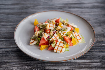 Salad with mozzarella cheese and oranges. 