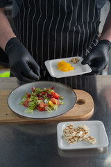 The chef lays out the salad. 