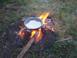 campfire in the forest The first firing of the cauldron over an open fire with table salt