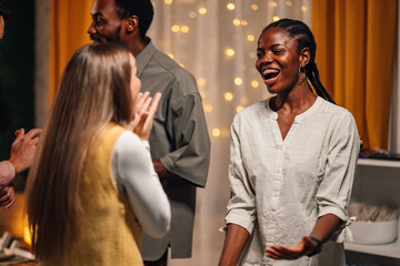 Friends celebrating, talking and having fun at home party
