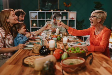 Happy family toasting during thanksgiving dinner at home