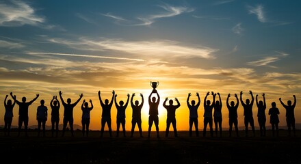 Silhouettes of a Triumphant Team Celebrating Victory with a Trophy at Sunset