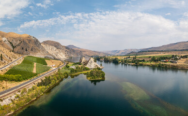 Fototapeta premium Aerial drone view of Columbia River by Maplecreek and Orondo in Washington with two rock outcroppings in the river