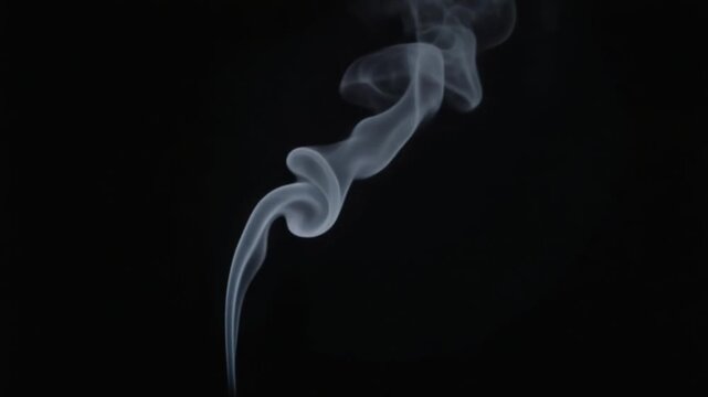 White smoke from an extinguished match on dark background