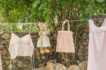 Different clothes drying on laundry line against garden background,clothes hanging laundry on washing line for drying towels drying on the clothesline.