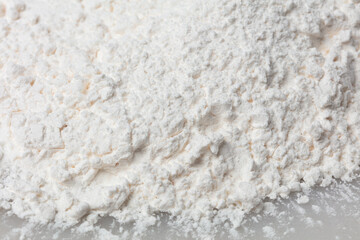 Close up Pile of Tapioca starch explosion flying, White powder tapioca starch wave floating fall down in air. tapioca starch is element material. Eyeshadow crush for make up artist. White background
