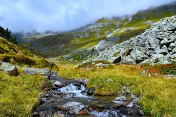 Stream of water flowing down an alpine landscape in in Hintereggengraben alpine valley in Reisseck group and Ankogel group of High Tauern in Central eastern alps, Carinthia, Austria