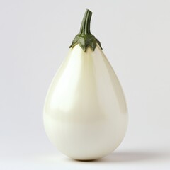 Elegant white eggplant with a smooth, glossy surface and vibrant green stem against a light background.