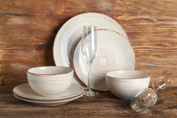 Set of clean dishes on wooden table