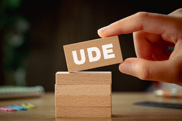 There is wood block with the word UDE. It is an abbreviation for Undesirable Effect as eye-catching...