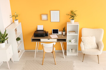 Fototapeta premium Workplace with modern printer and laptop in stylish home office