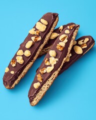 Deliciously coated chocolate biscotti topped with nuts, perfect for a sweet snack or coffee companion.
