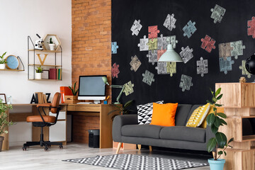 Stylish interior of teenager's room with chalk drawing on black wall