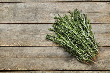 Fresh rosemary twigs on wooden background