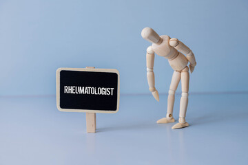 On a gray background, a stethoscope and a cardboard sign with the inscription - Rheumatoid arthritis